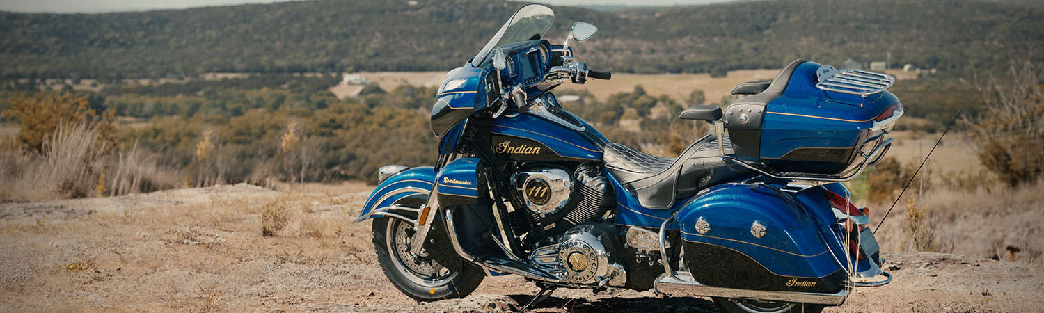 A blue 2020 Indian Motorcycle® Roadmaster Elite Hero touring motorcycle in the desert.